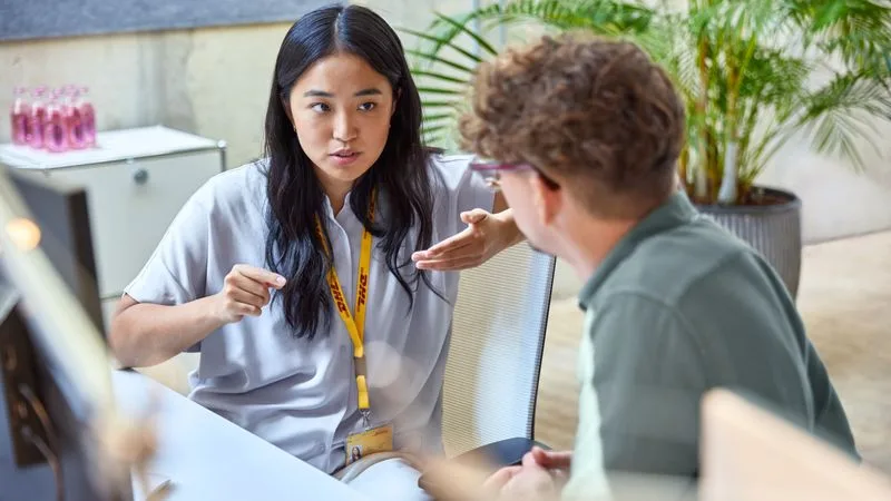 dhl employee guiding a customer through customs duties and taxes