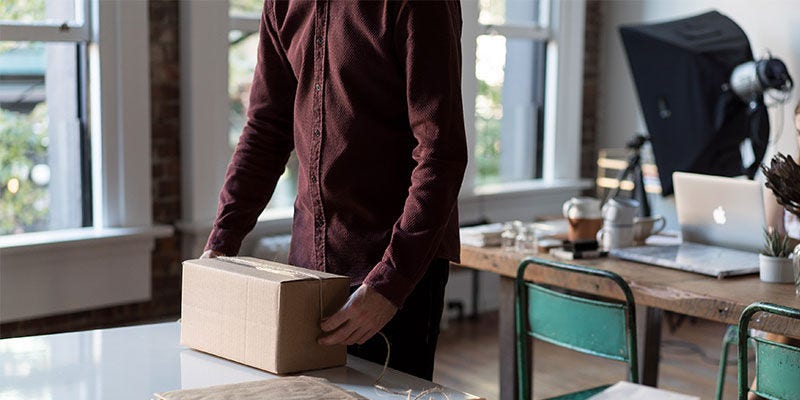 Man tying string around a parcel