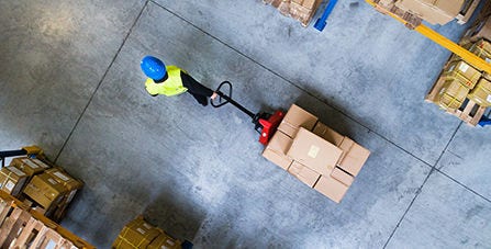 person pulling shipping trolley