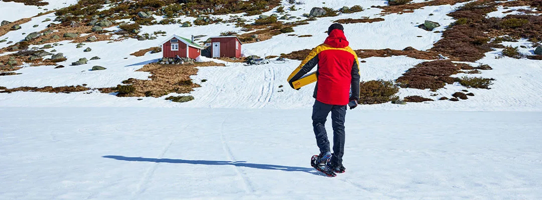 DHL courier delivering parcel in a snowy location