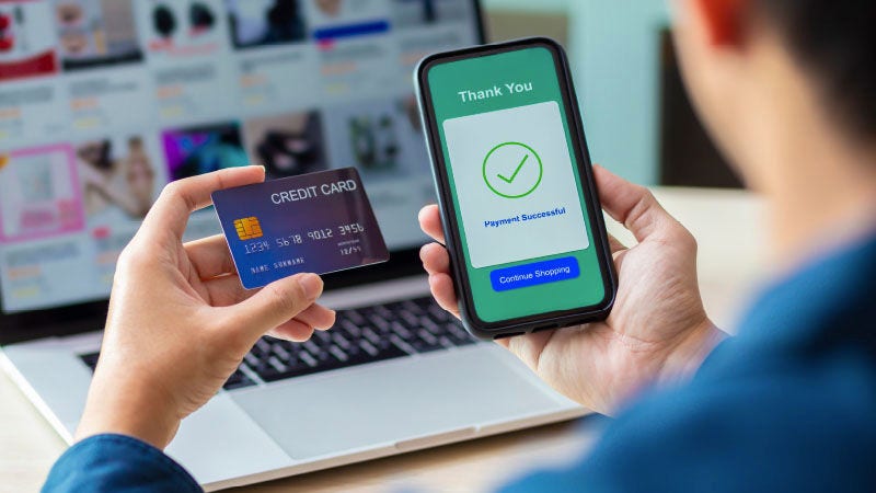 man holding mobile phone and card