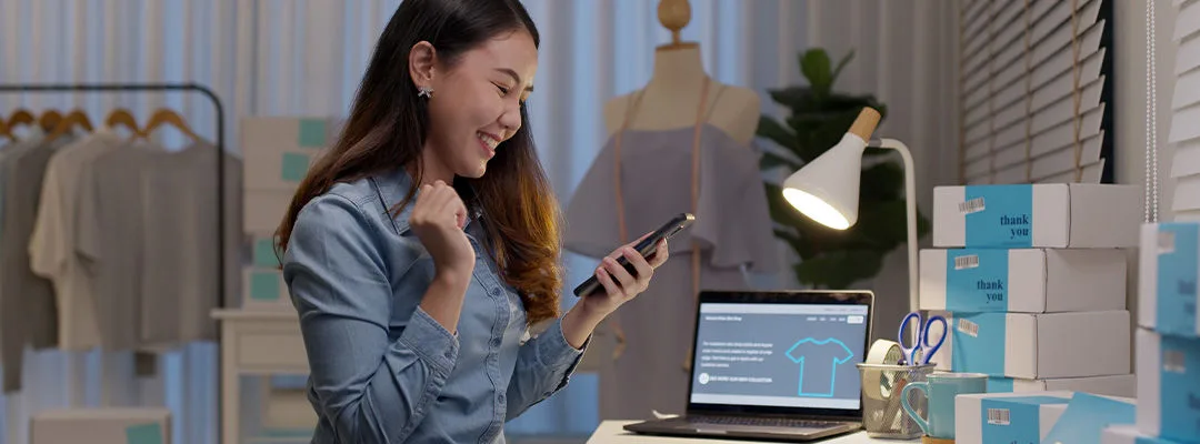 woman smiling and swiping on mobile phone screen