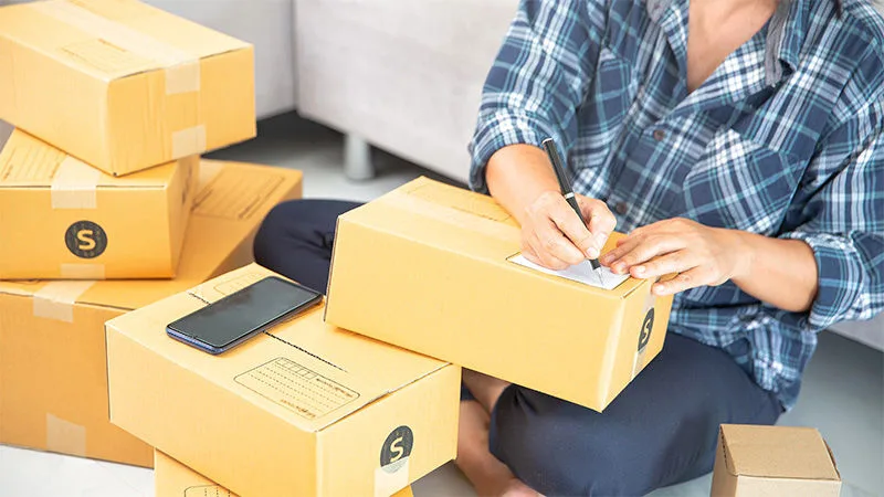 woman labelling parcels