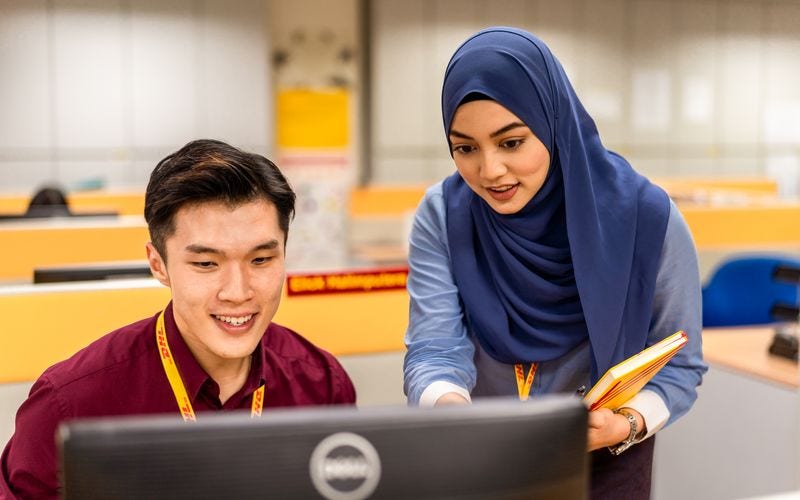 male and female dhl employee having a discussion in the office