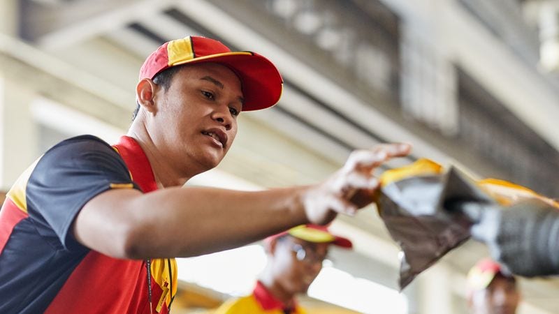 dhl express employees sorting through a shipment