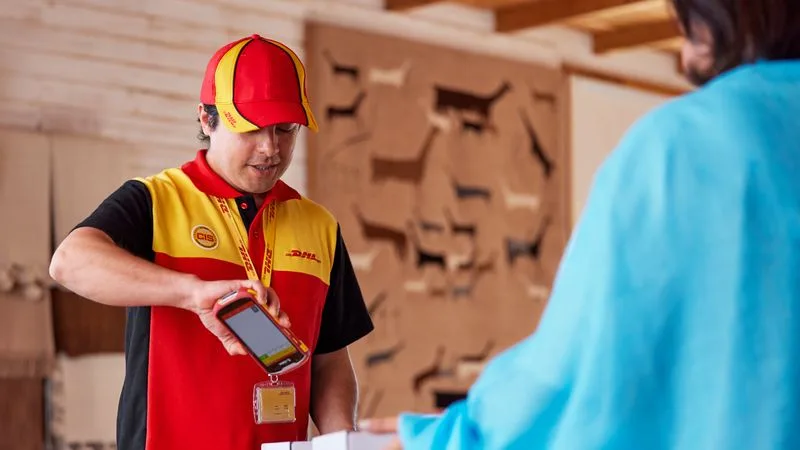 DHL employee is scanning parcels for pickup