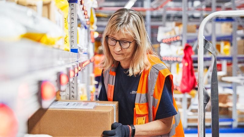 a dhl employee checking the tracking information on a packaging material