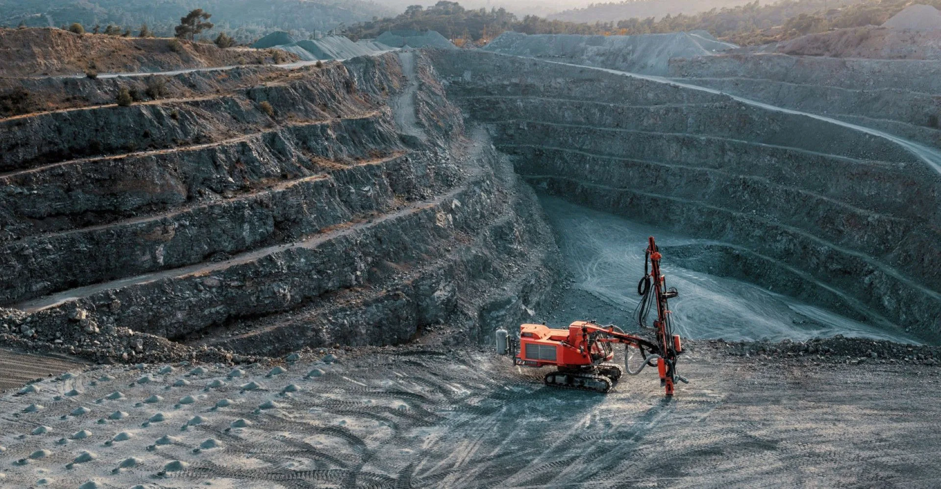 Red stone crusher on a terrace of gravel quarry.
