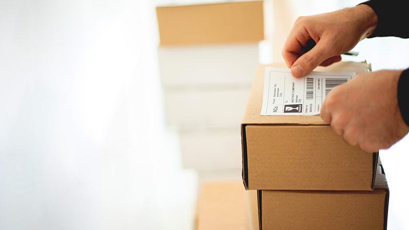 hand sticking label on parcel