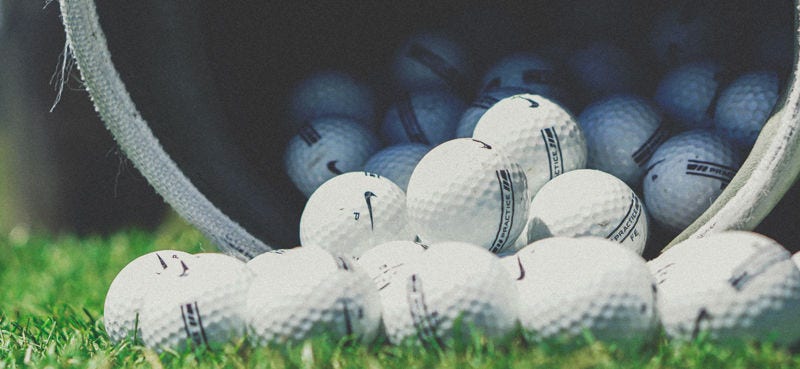 White golf balls on grass