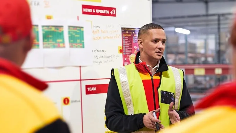 DHL staff conducting briefing on international shipping 