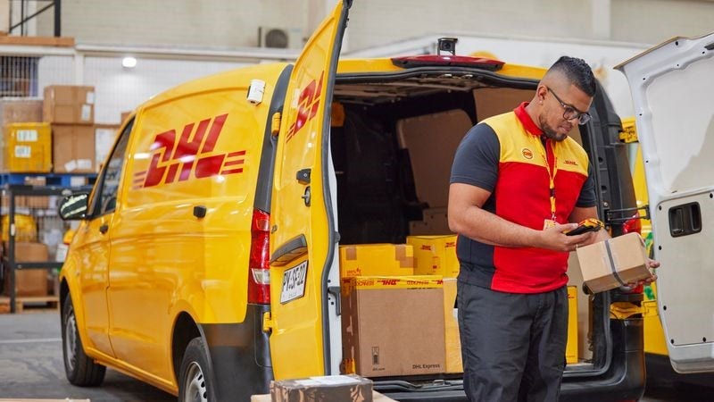 DHL Express employee checking packages for delivery in Saudi Arabia