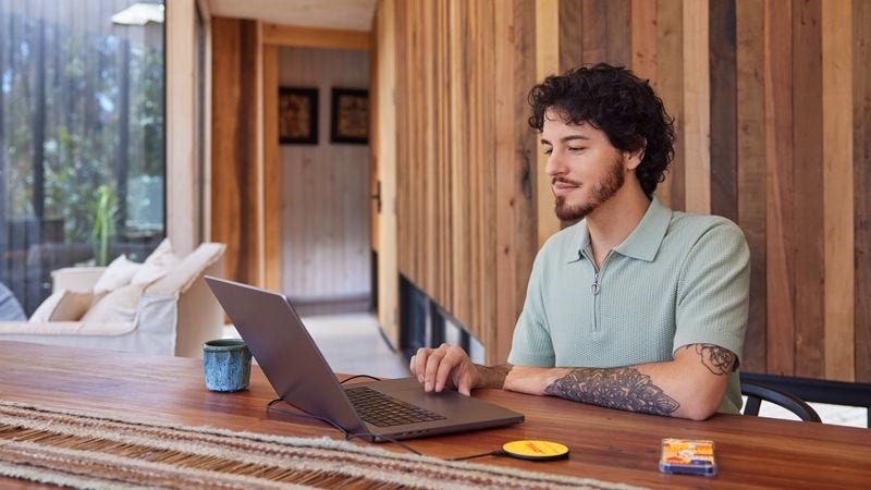 a young man browsing his laptop at home to order an international shipment