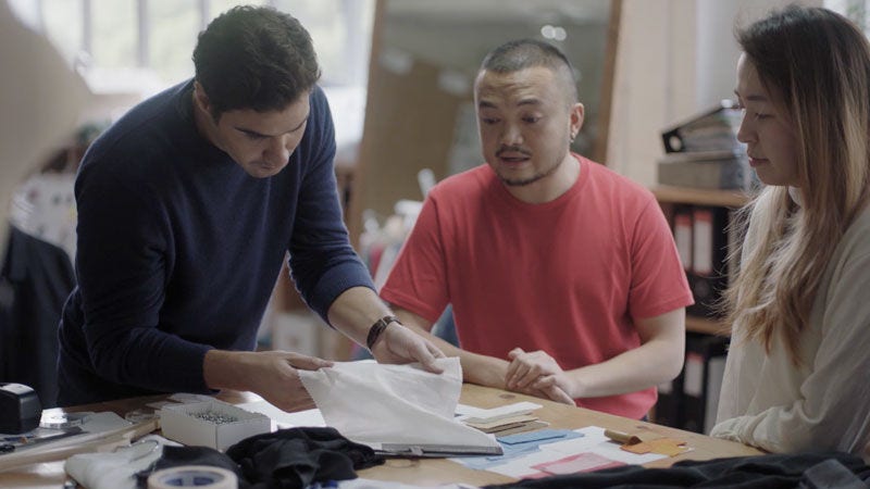 People sitting around work table choosing material