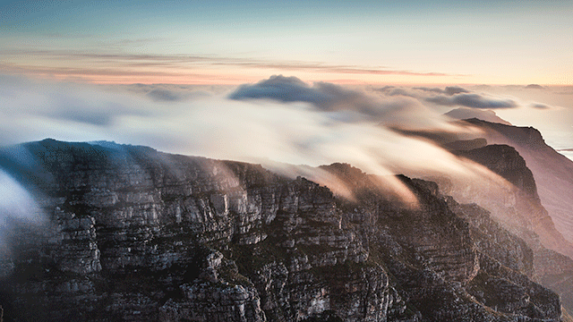 clouds on the peak of a mountain