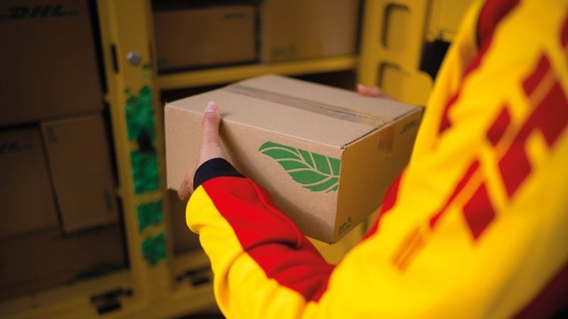 close up of dhl express employee loading a vehicle with other sustainable packages