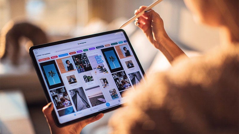 woman looking at tablet screen