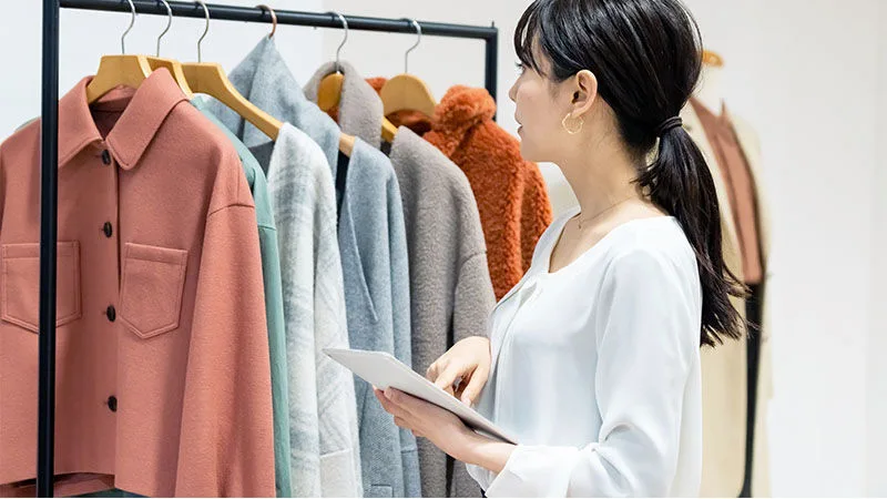 woman looking at clothes rack