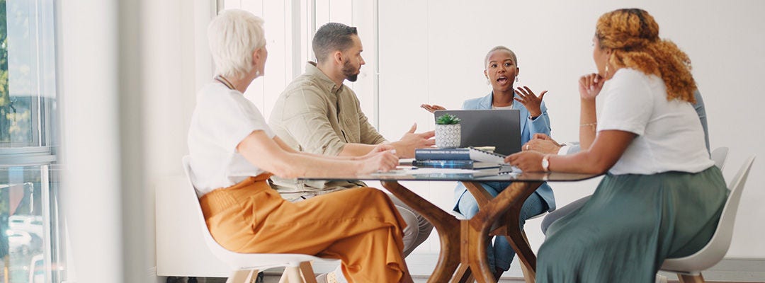 people around a table having a discussion