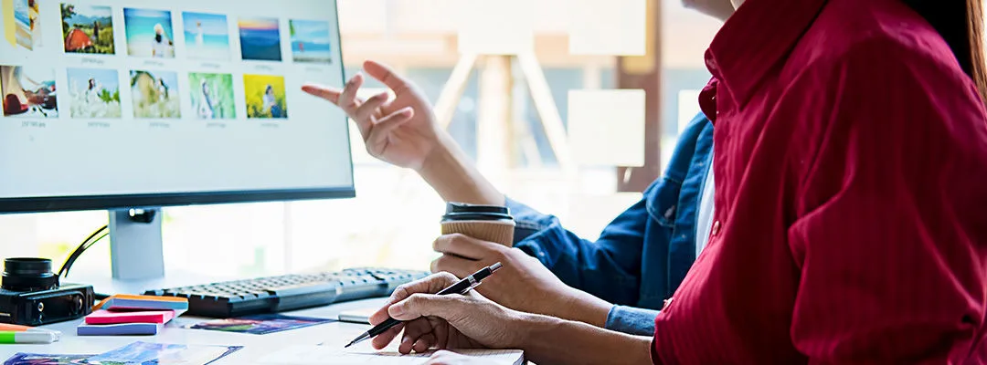 man and woman looking at computer screen