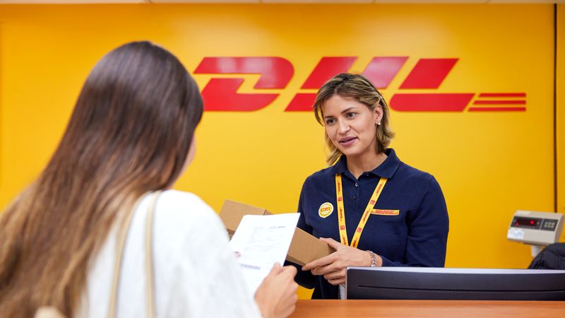 a business owner getting information from dhl employee about mydhl+