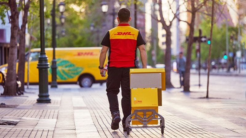 dhl express australia employee walking back to van 