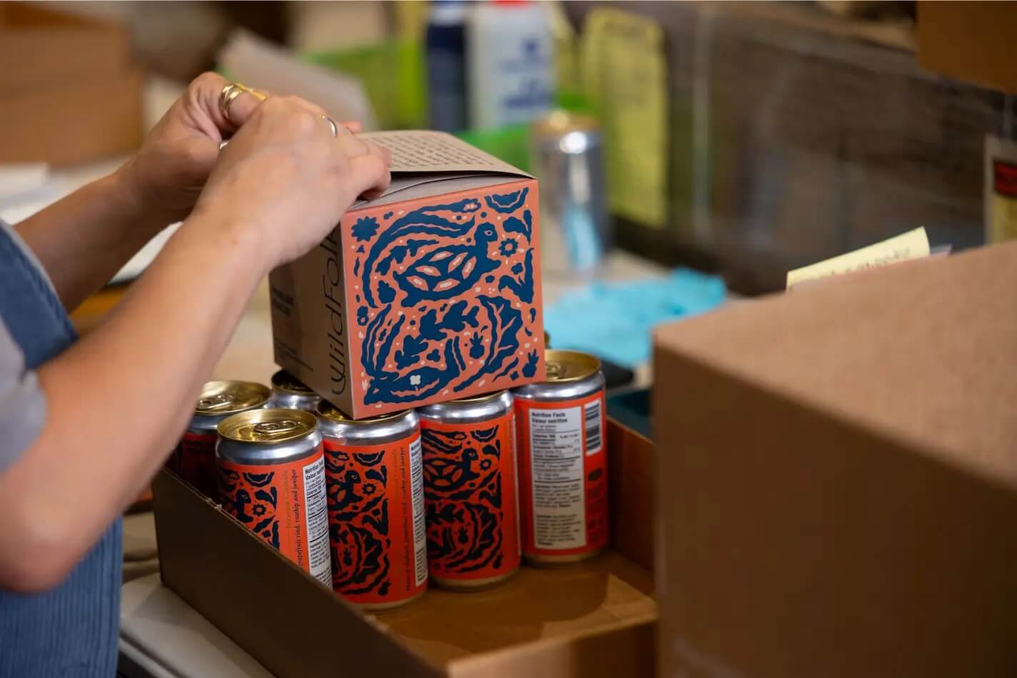 Packaging cans of Wild Folk cocktails