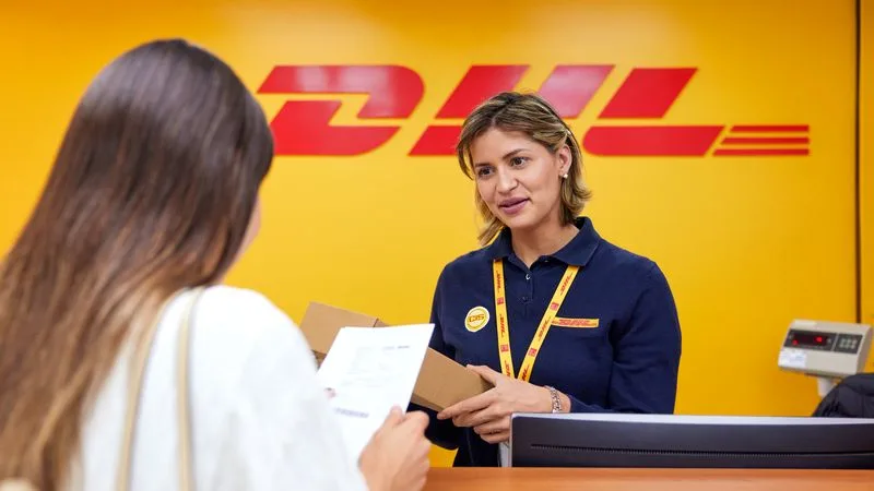 A DHL service staff member assisting a customer