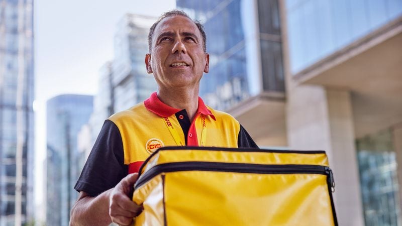 A DHL Express employee delivers items in temperature-controlled packaging.