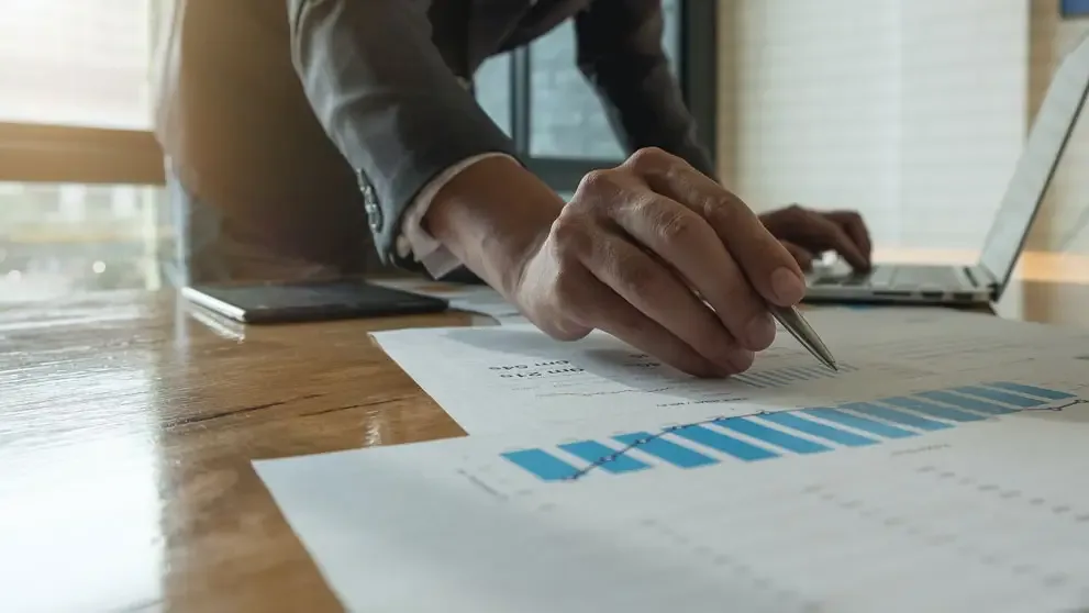 a person checking a spreadsheet