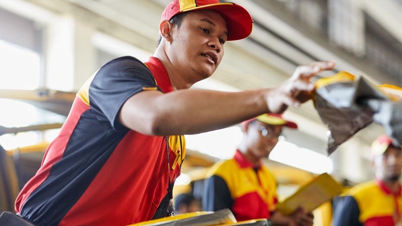dhl express staff sorting parcels