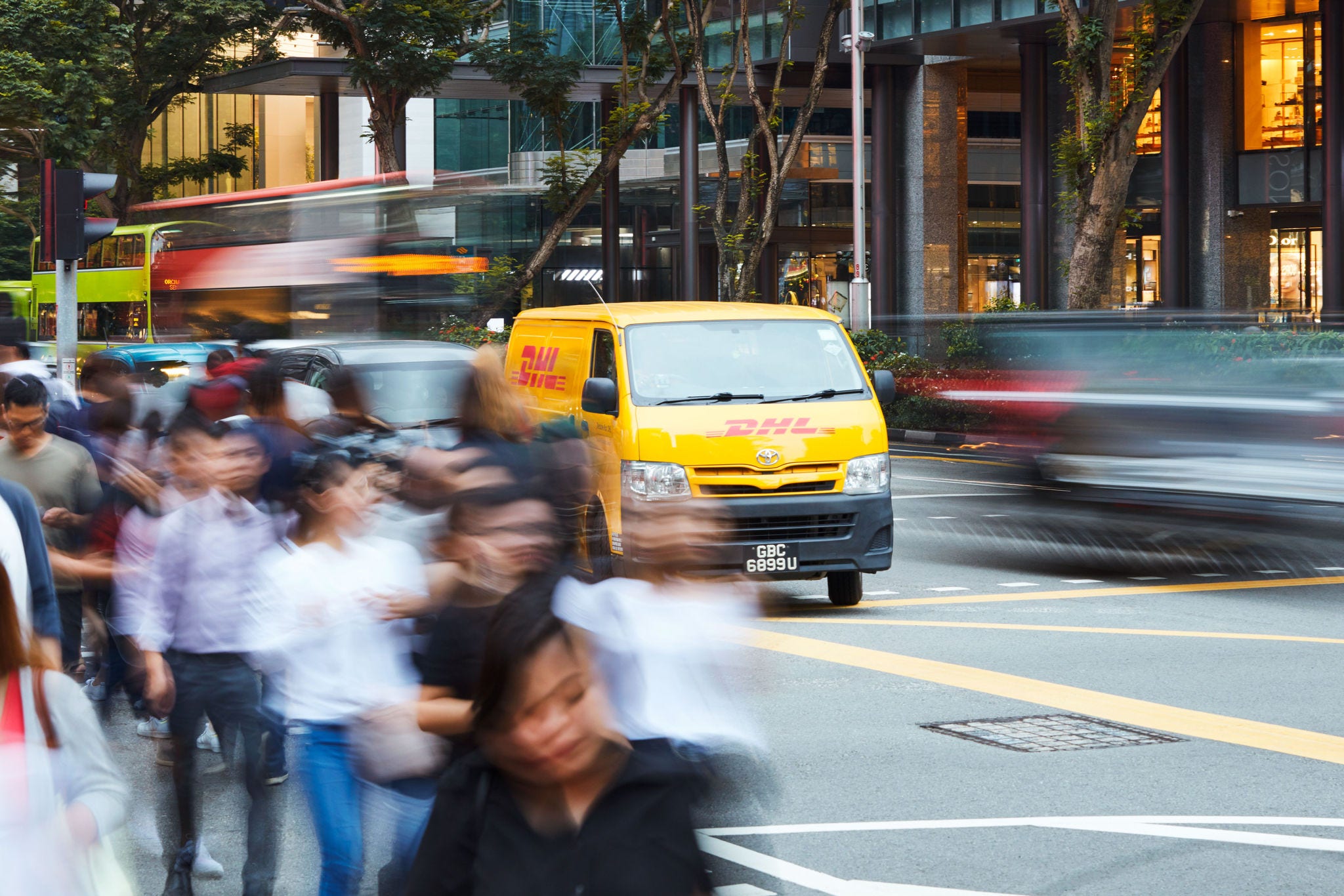 DHL courier van carrying out international e-commerce shipping and delivery