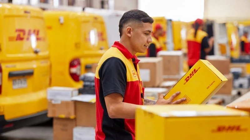 a dhl employee sorting out the parcels at a dhl collection hub