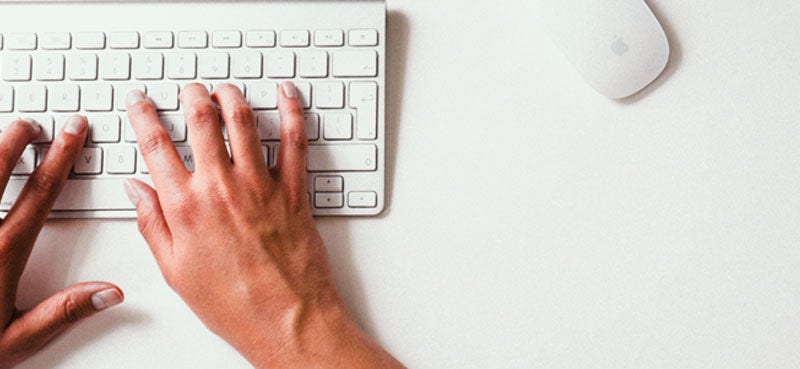 Hands typing on a keyboard