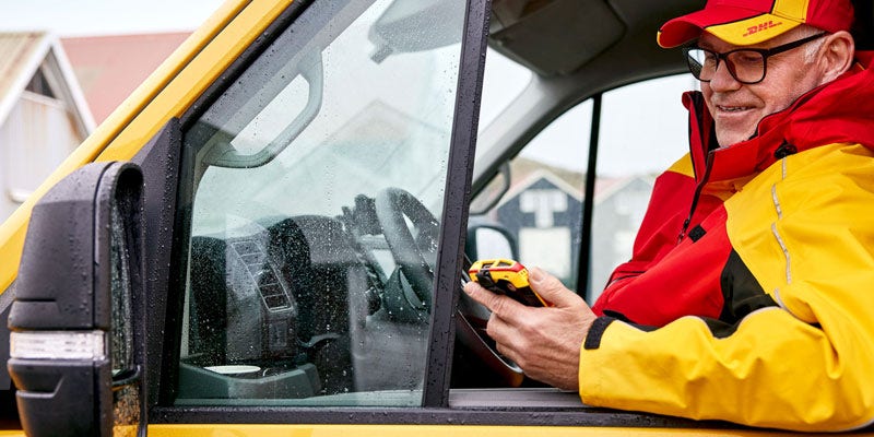 courier with scanner in a van