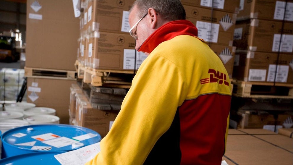 dhl employee inspecting for customs clearance
