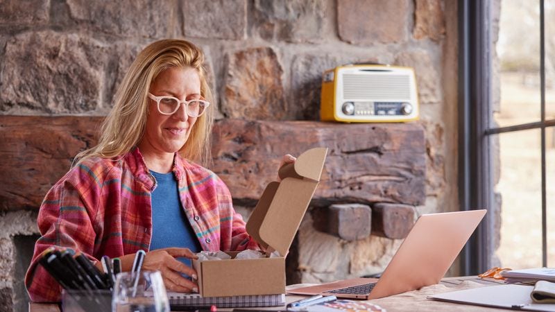 business owner packing products for international shipping