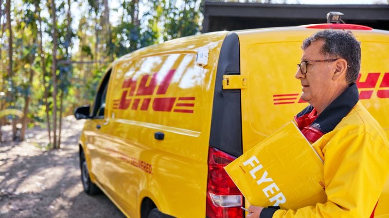 DHL courier service personnel delivering a parcel