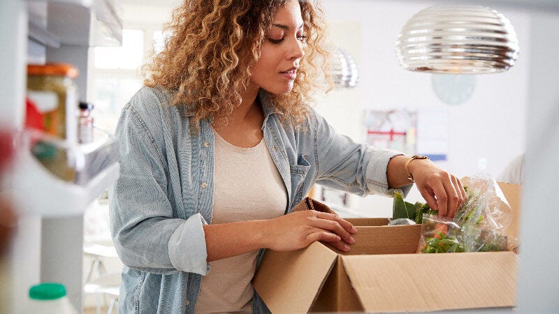 woman opening boxes