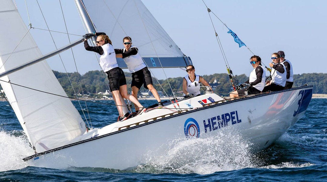 A sports sailing boat being piloted by crew