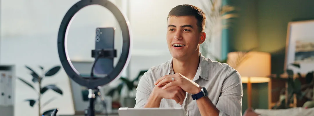 young man influencer speaking into a camera