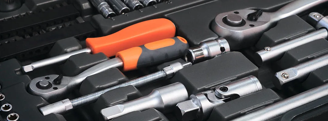 A toolbox with many different tools including pliers, wrenches, and screwdrivers. The tools are organized in a way that makes it easy to find what you need