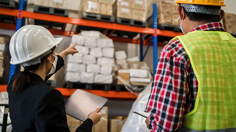 warehouse workers looking at packages