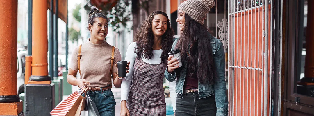 three women smiling shopping