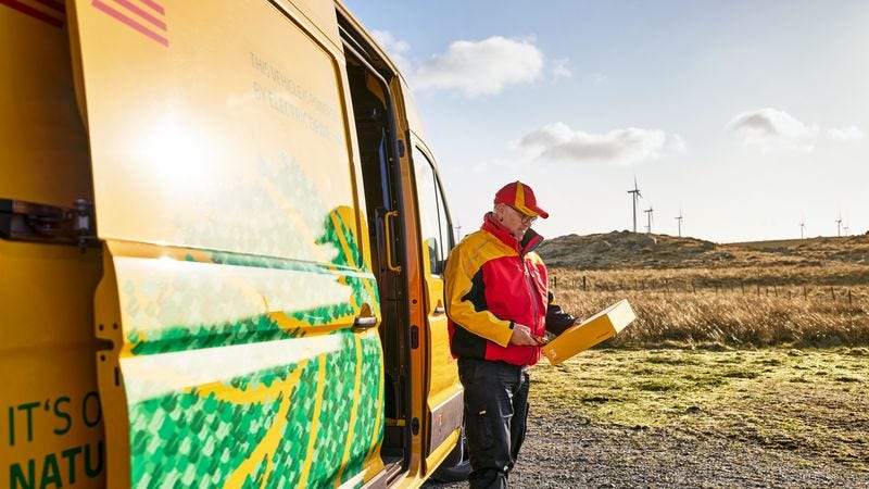 DHL employee taking out a parcel from the van for delivery