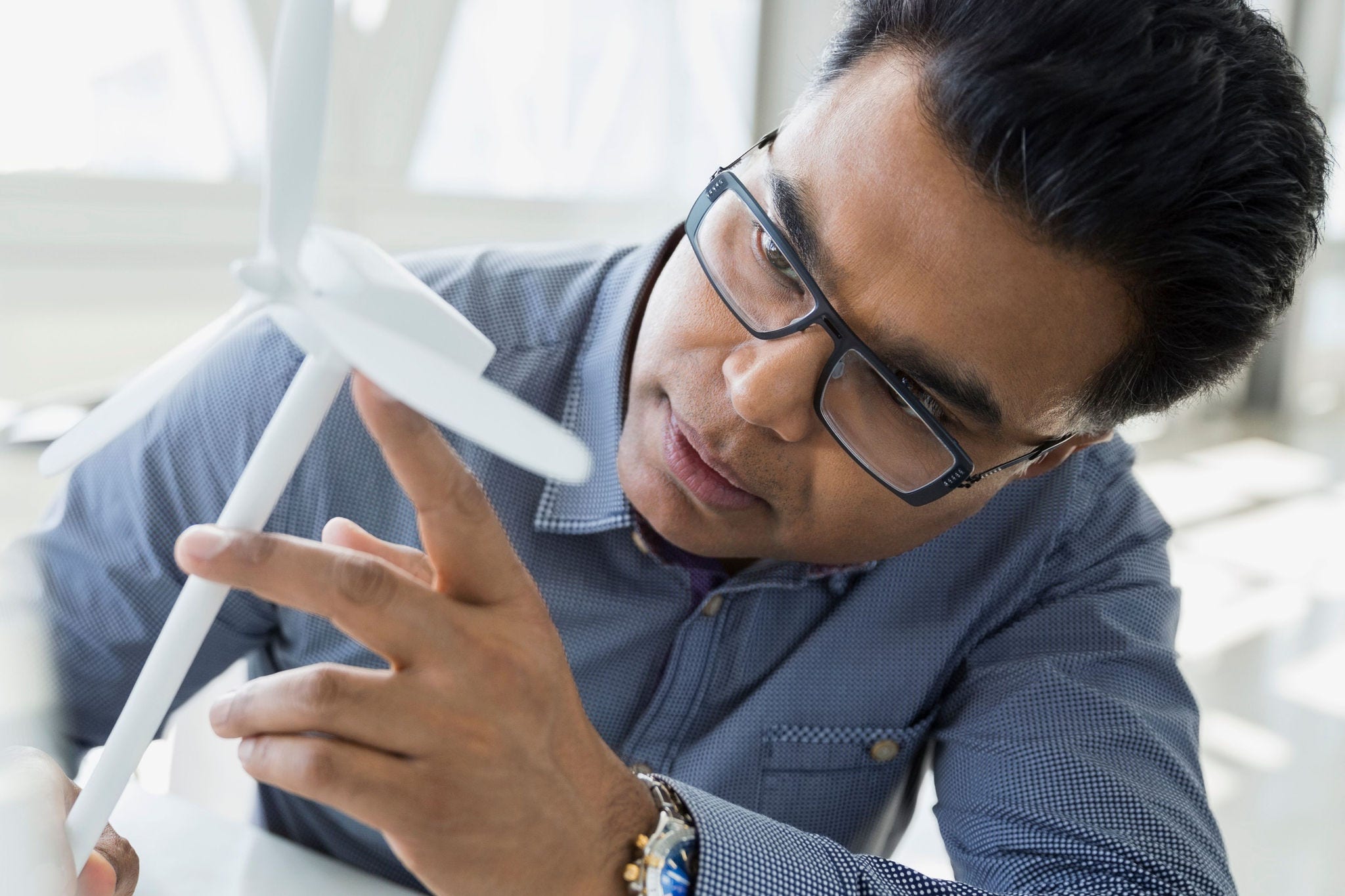 A product designer scrutinises a prototype that is planned for release into the market as part of his company’s diversification of a product line