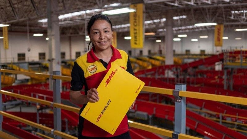 DHL Express courier holding onto a legal envelope