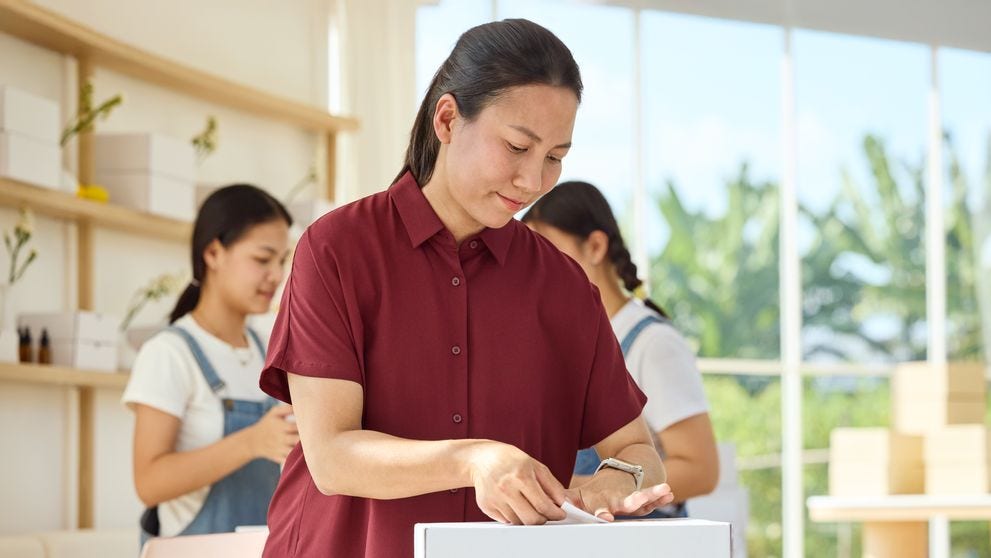shop owner sticking a label for international shipment