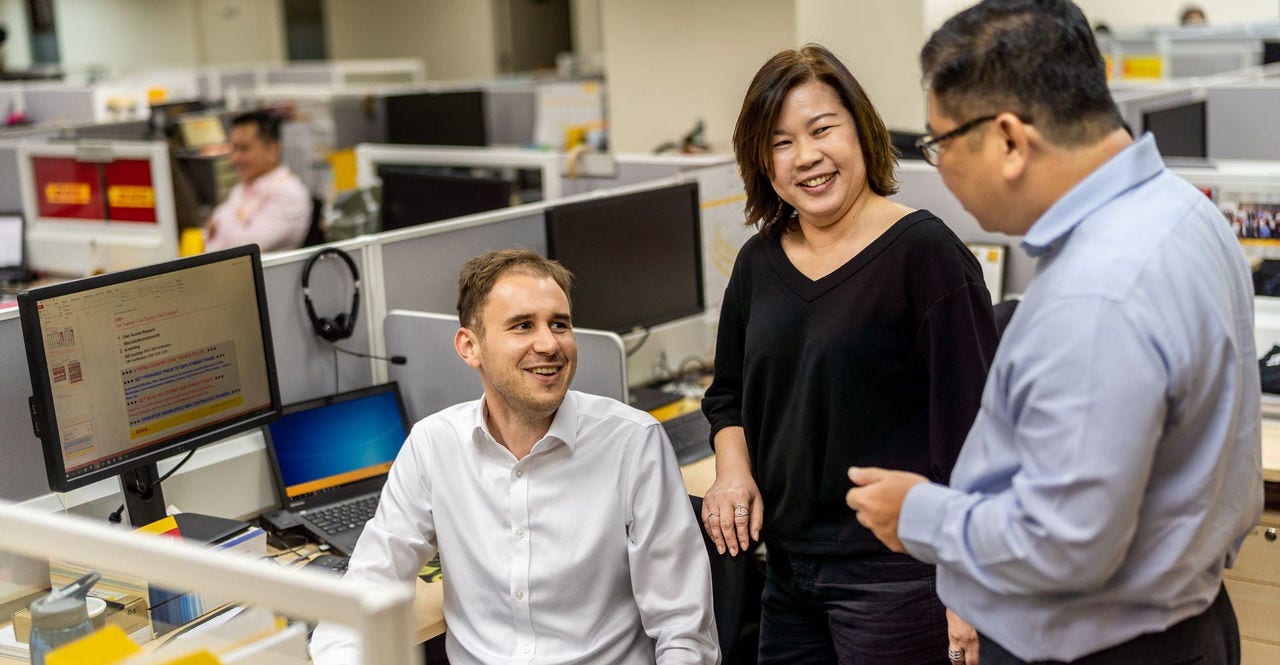 colleagues from the business development unit discussing the next step in starting a new sme in myanmar 