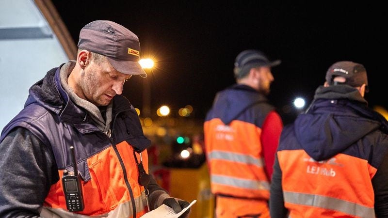 dhl employee checking on international delivery 